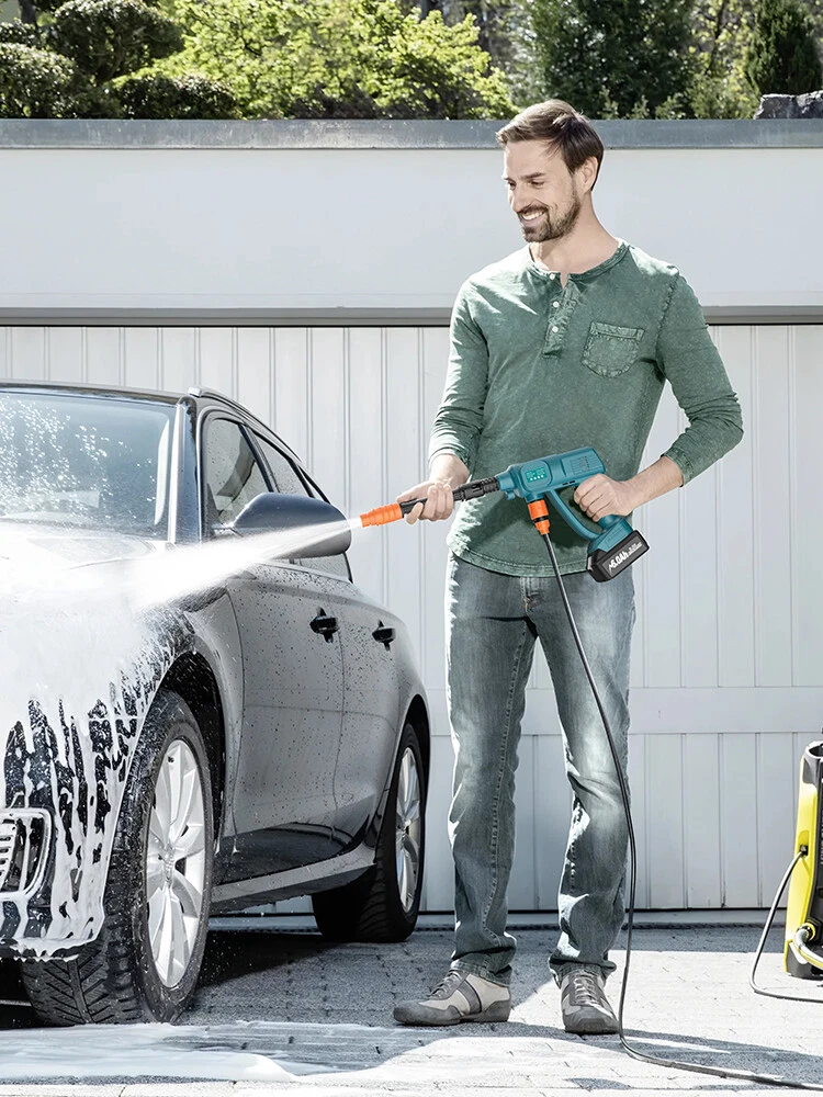 Portable cordless washer in use on a vehicle